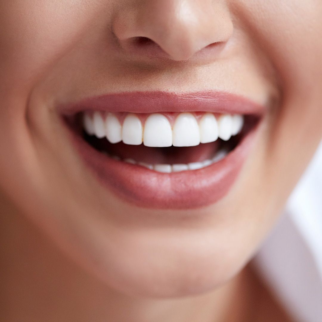 Smiling face with bright, white teeth.