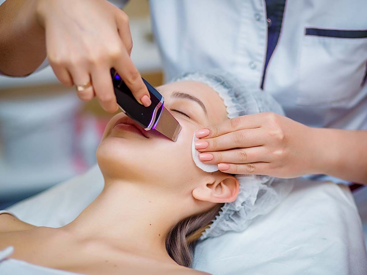 Woman receiving a facial treatment at a spa.