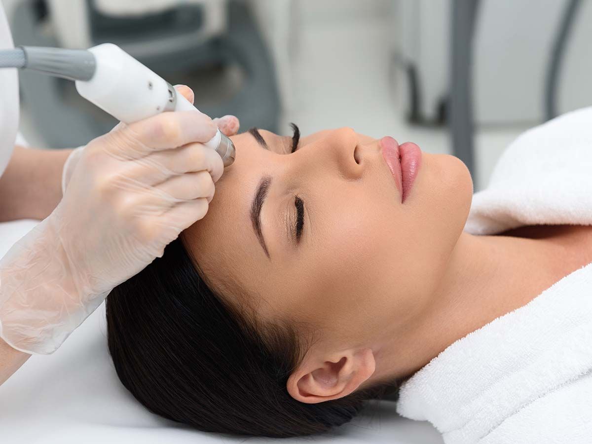 Woman receiving facial treatment in a clinic.