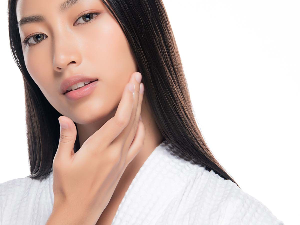 Young woman smiling with long brown hair.