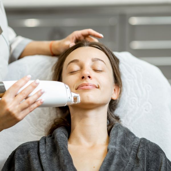 Woman receiving a facial treatment in spa.