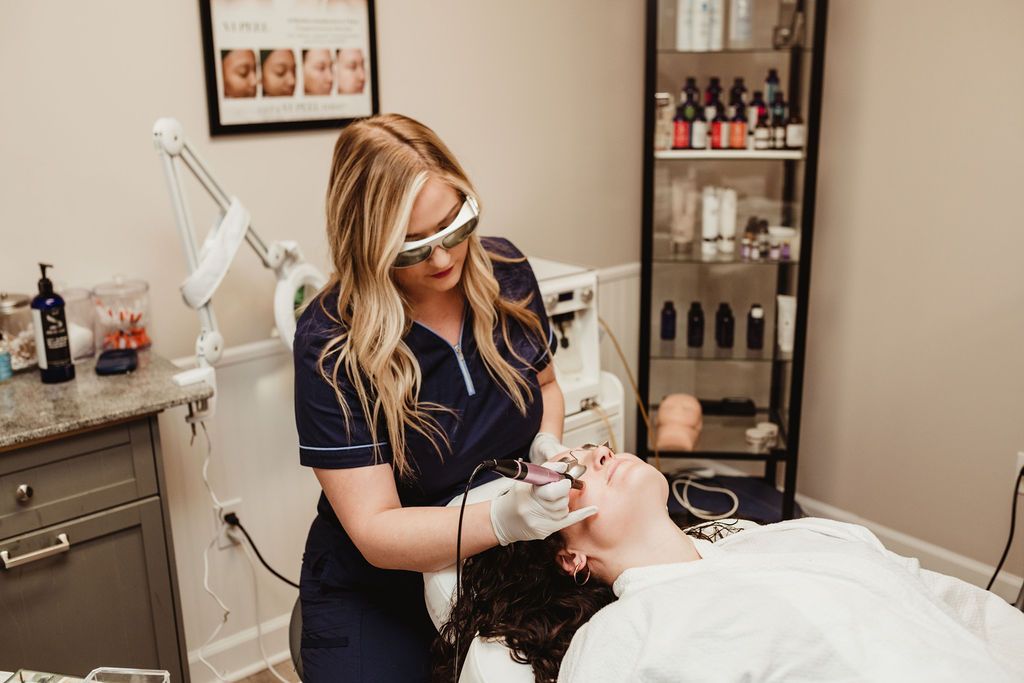 Woman receiving facial treatment in beauty clinic.