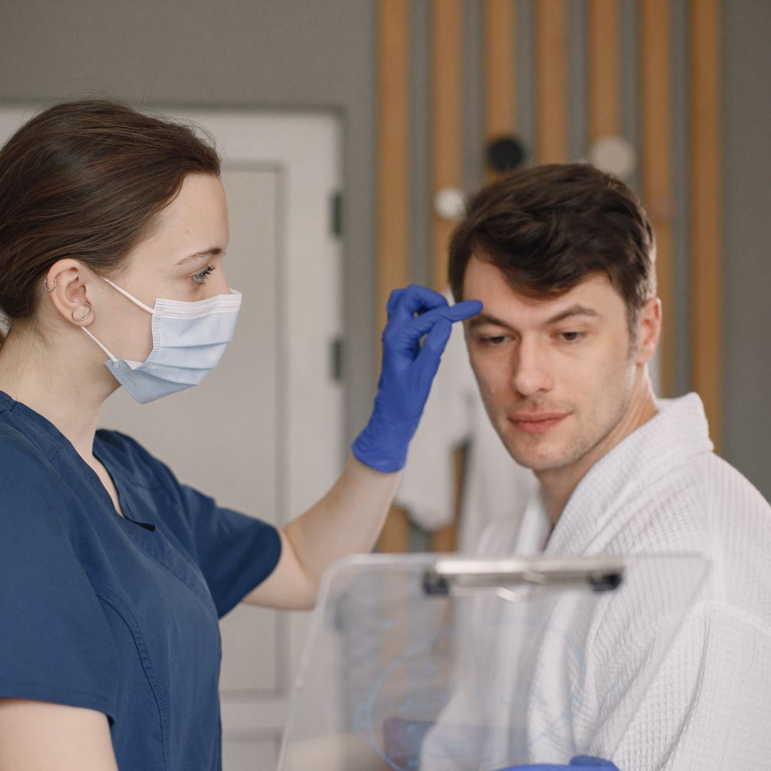 Healthcare professional assisting patient in consultation.