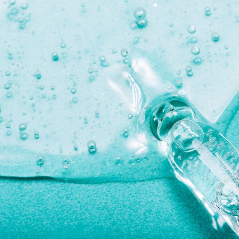 Clear liquid and bubbles on textured surface.