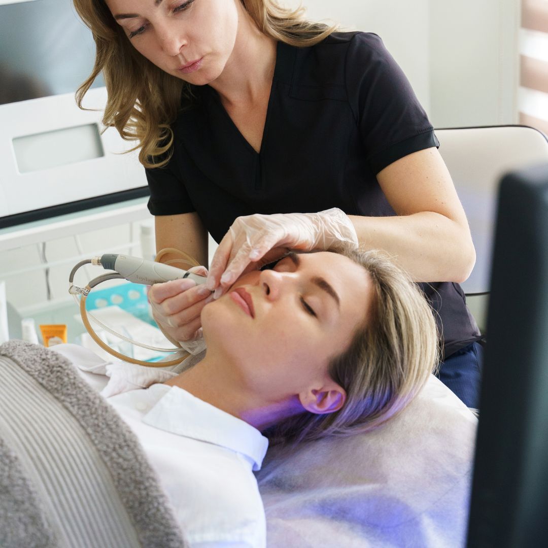 Woman receiving facial treatment in a spa.