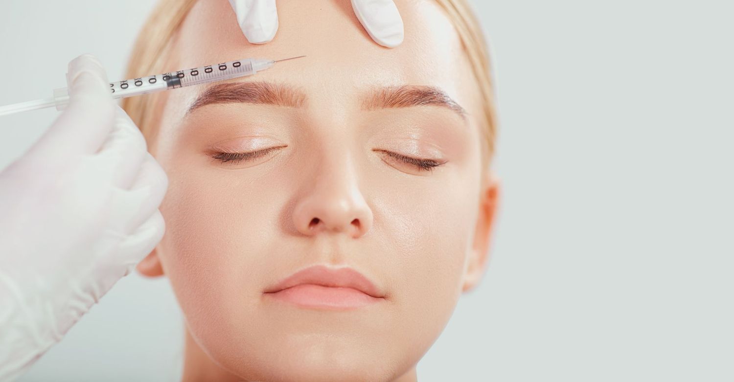 Administering a cosmetic injection to a patient.