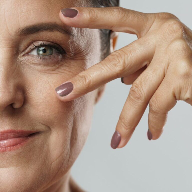 Close-up of a woman smiling, hand gesture.