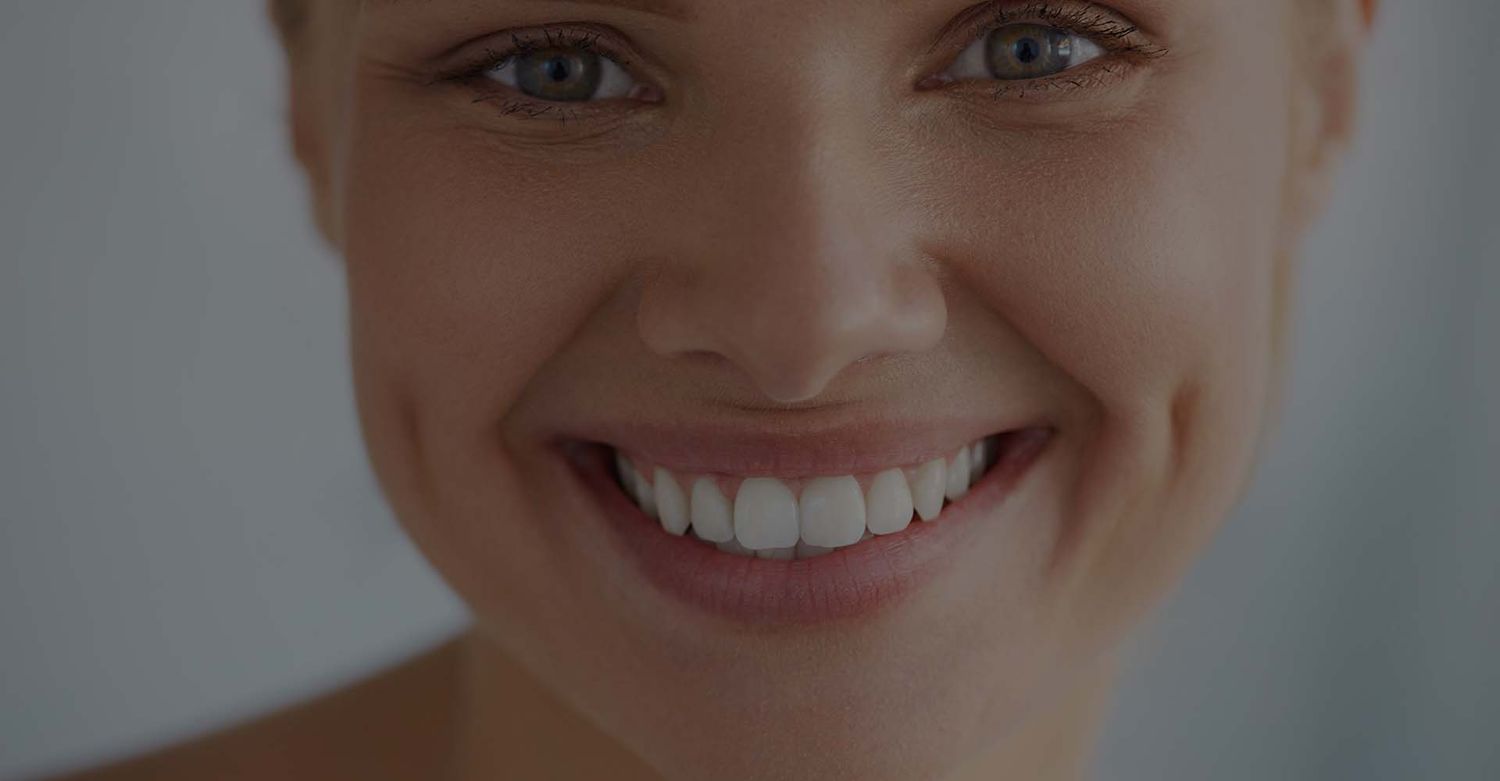 Smiling woman with bright, white teeth.