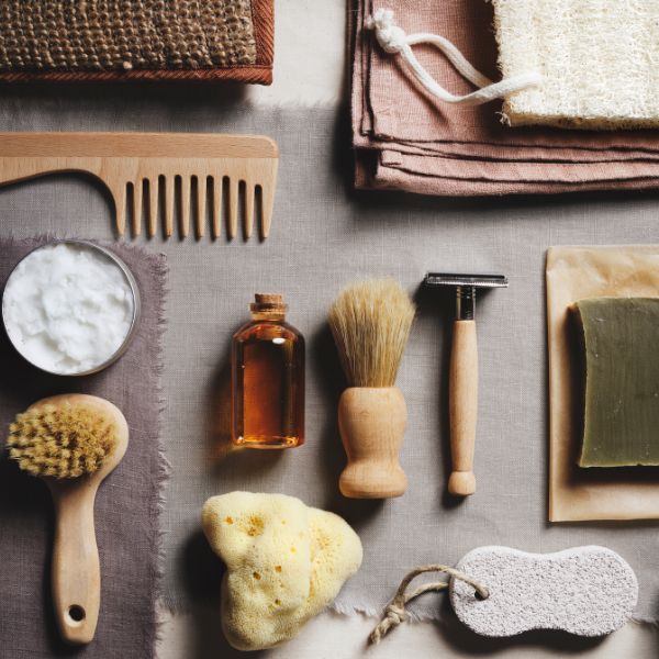 Assorted grooming and bathing tools on fabric.