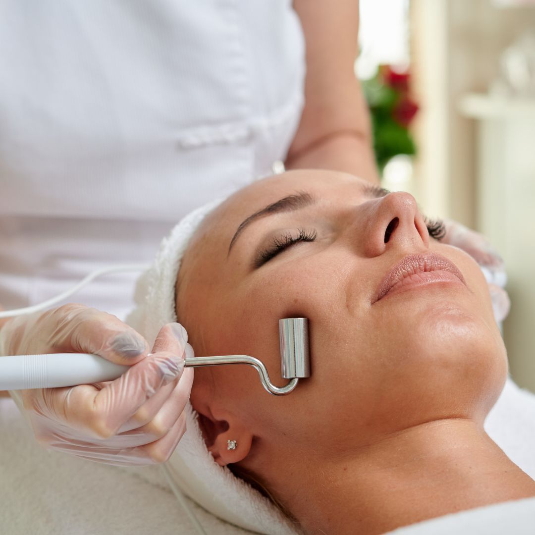Woman receiving facial treatment in a salon.