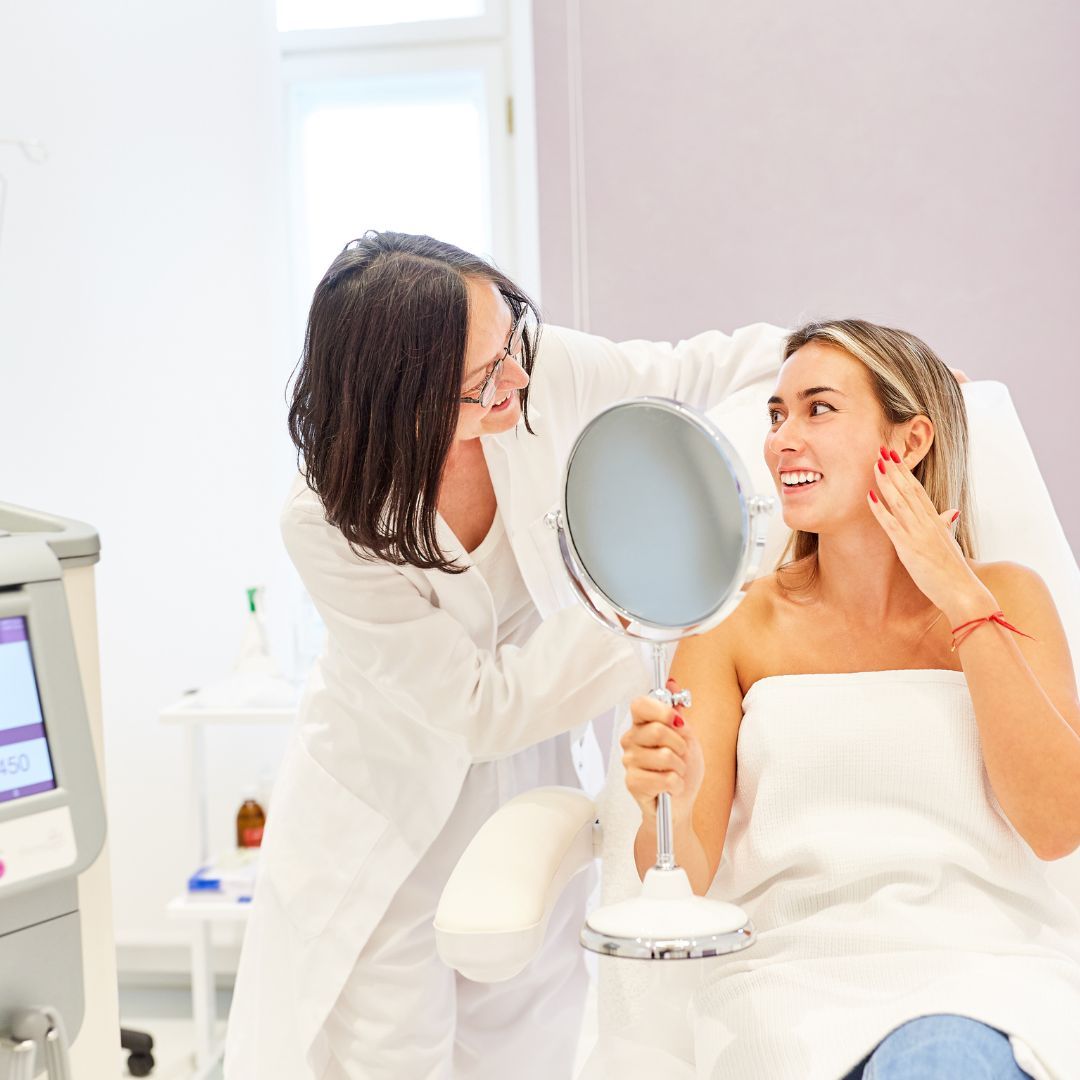 Patient receiving skincare consultation in clinic.