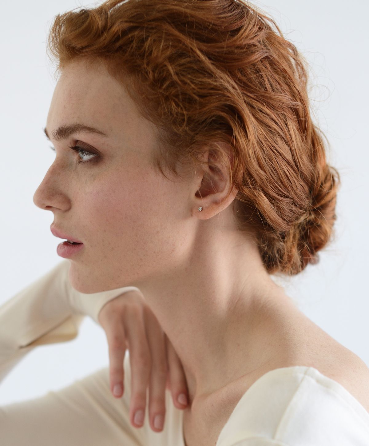 Profile view of woman with curly red hair.
