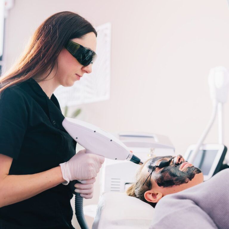 Facial treatment with laser and charcoal mask.