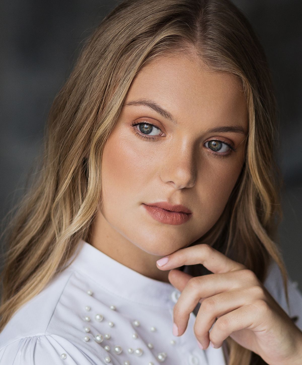 Young woman with light blonde hair and blue eyes.