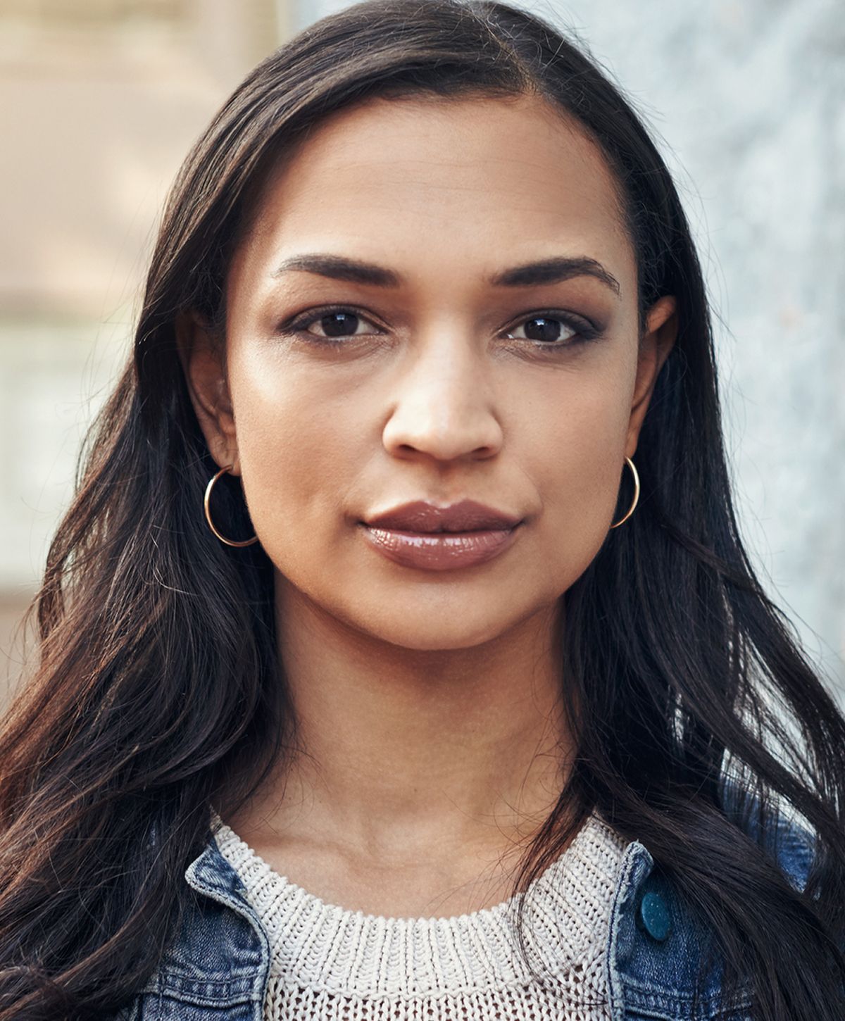 Woman with short hair and hoop earrings.