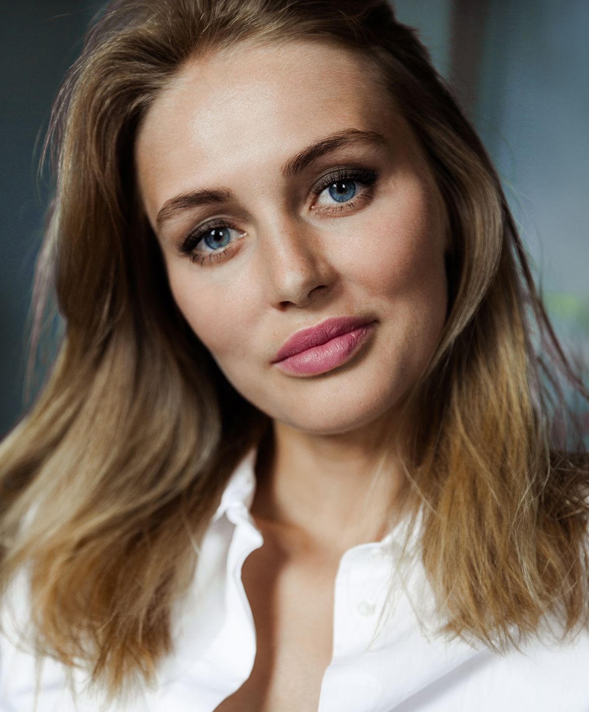 Young woman with light blonde hair and blue eyes.