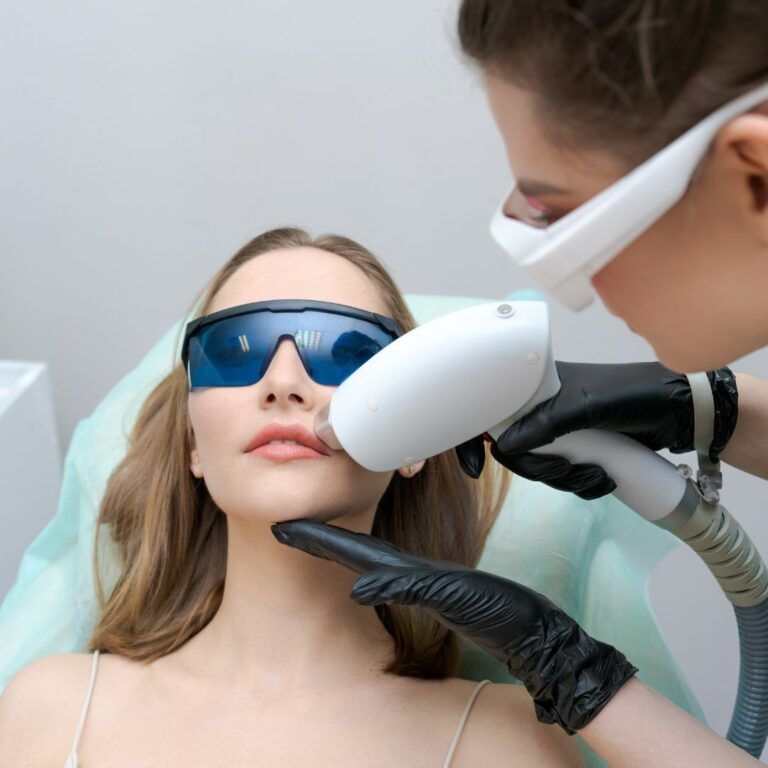 Woman receiving laser treatment for skin care.