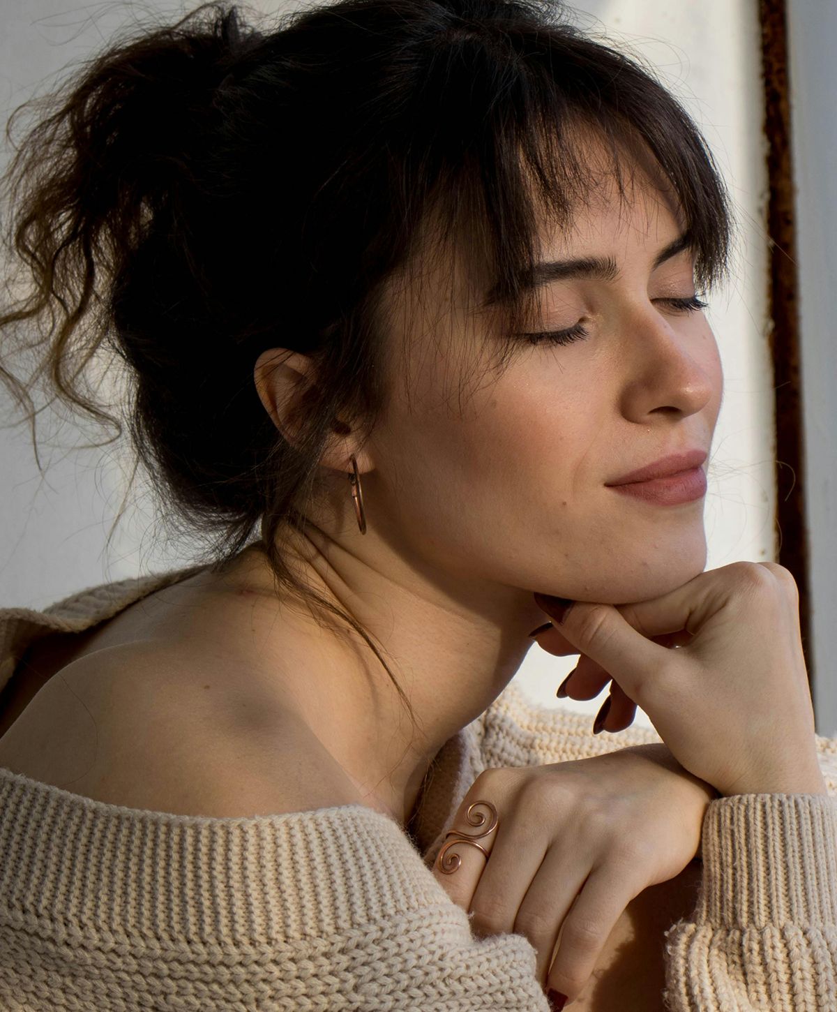 Woman with curly hair and natural makeup.