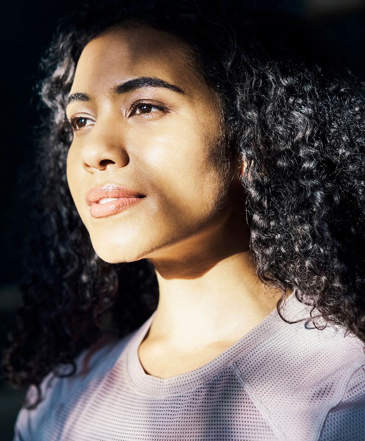 Smiling woman wearing a light blouse.