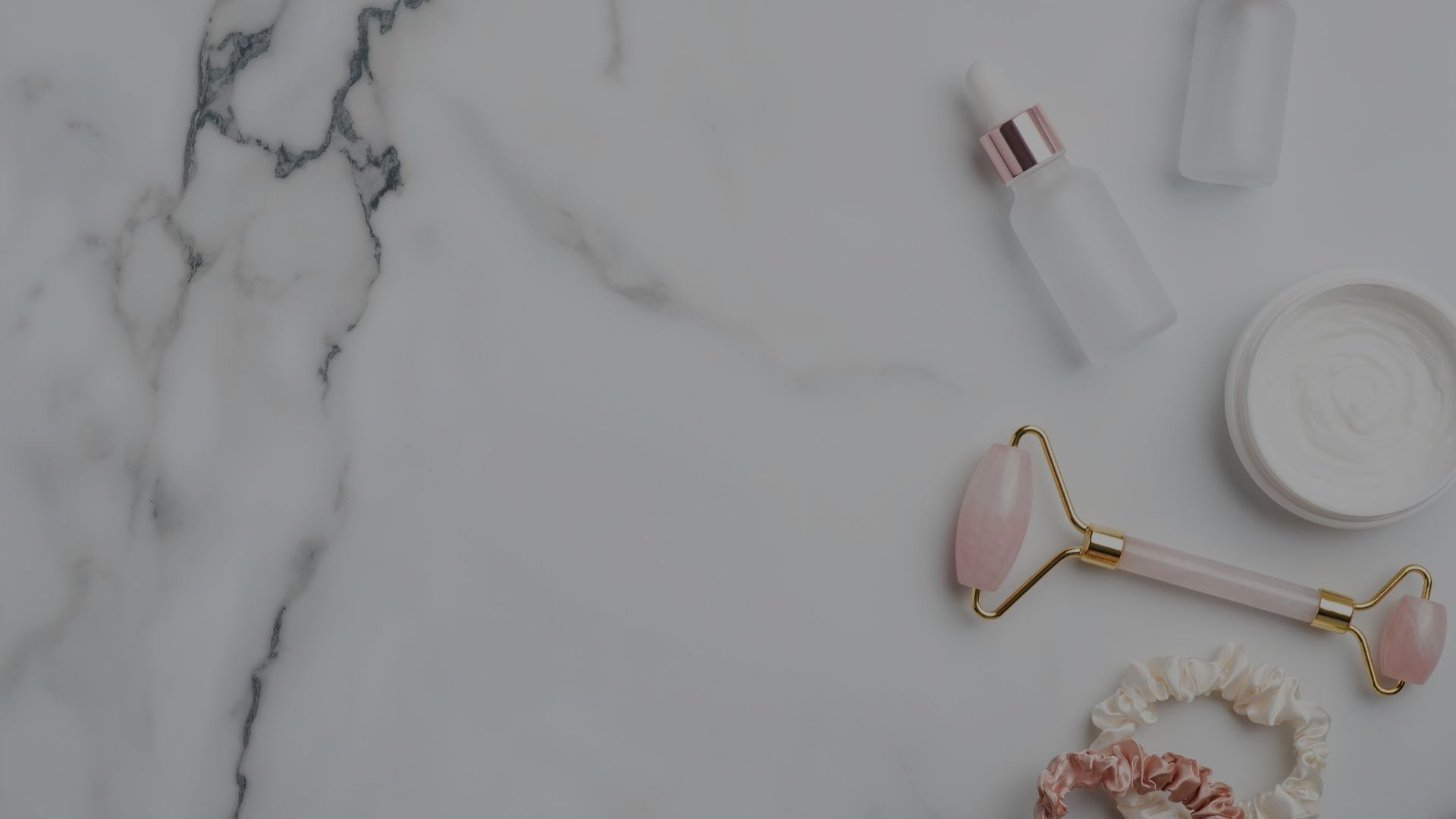 Skincare products on marble background.