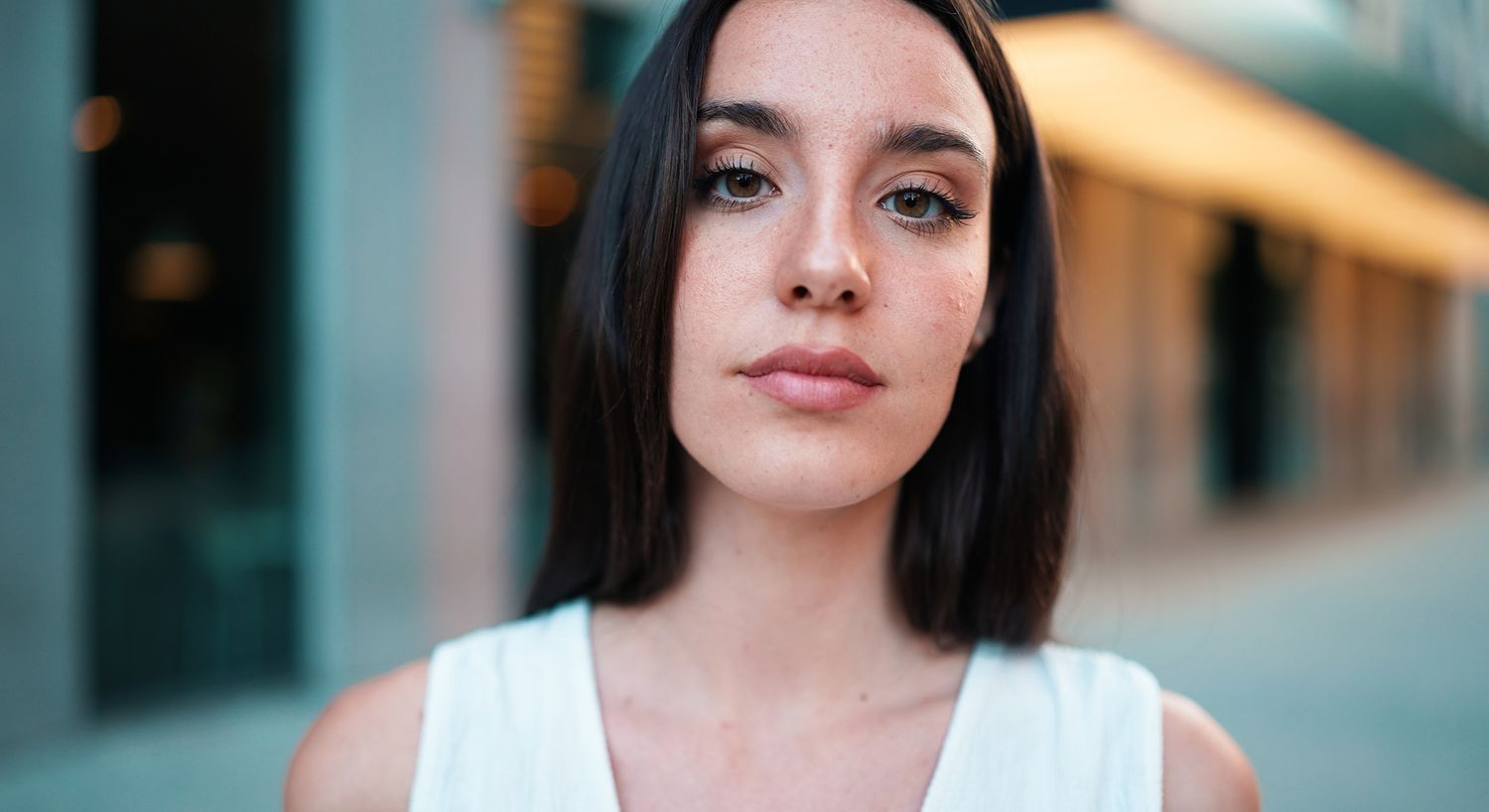 Young woman with long hair in urban setting.