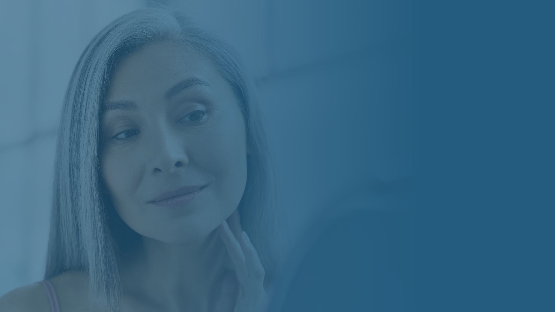 Woman looking at her reflection in mirror.