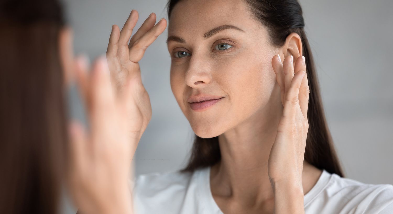 Woman receiving skin treatment with medical device.