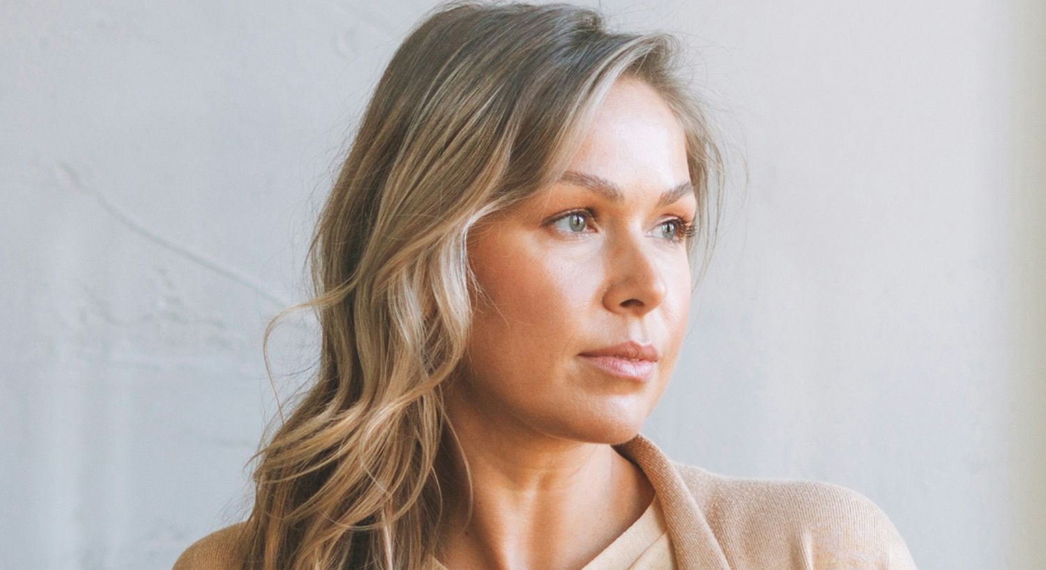 Woman with long hair gazing thoughtfully.
