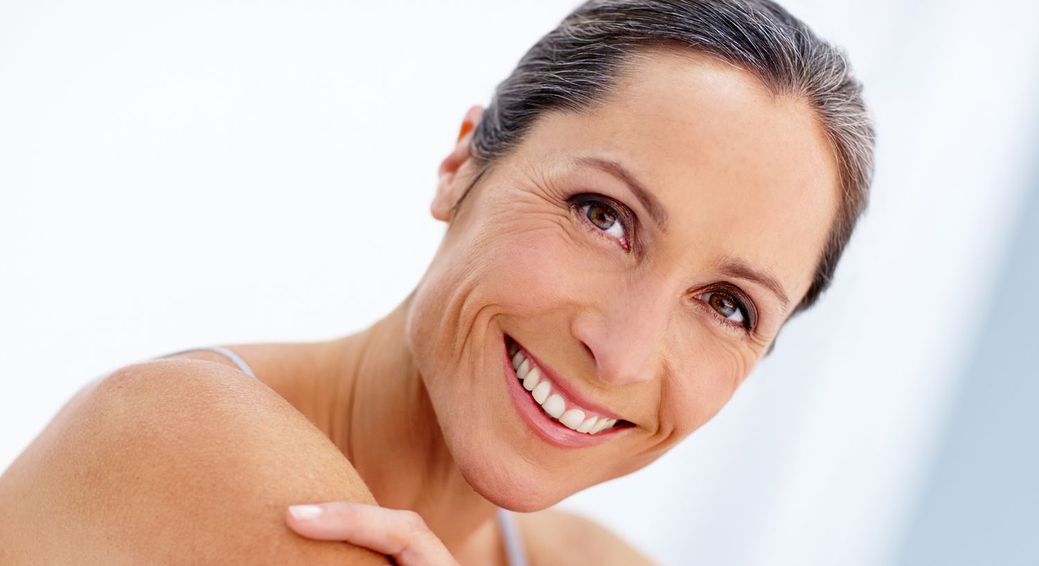 Smiling woman with shoulder-length hair.