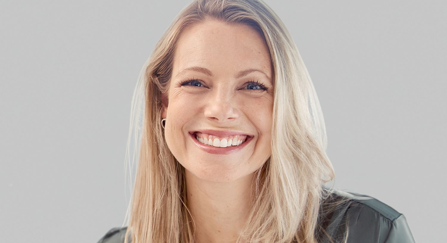 Smiling woman with long blonde hair.
